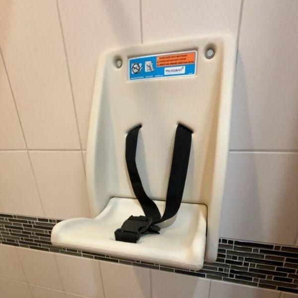 Child seat in shower stall at the pool