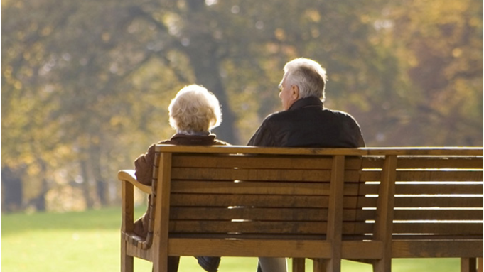 Two elderly sitting on a bench