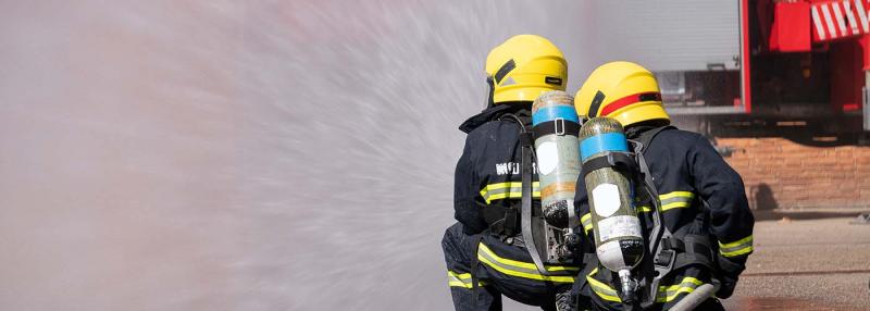 firefighters spraying with a hose