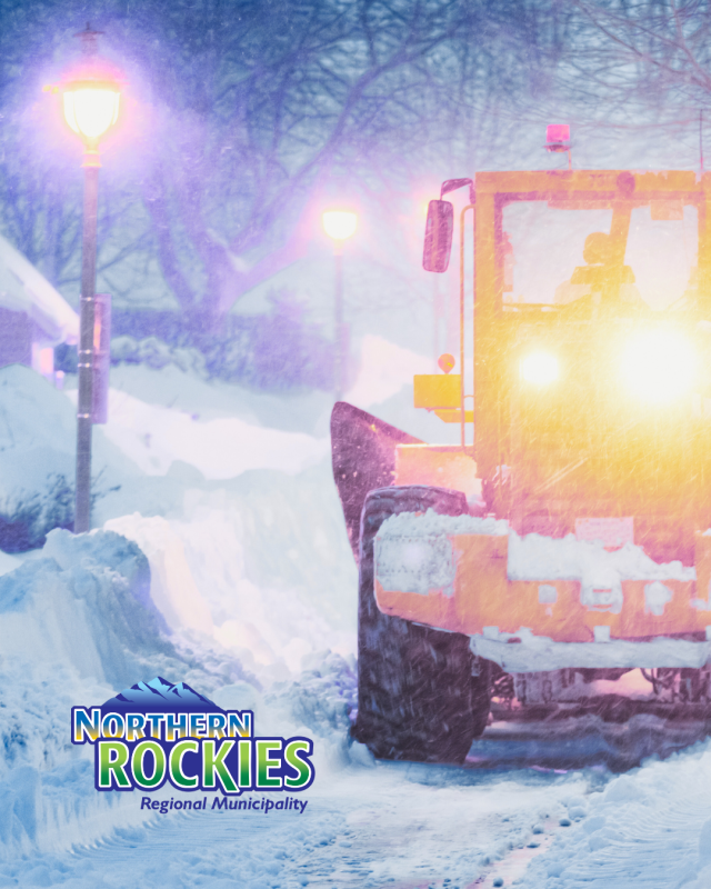 dozer plowing snow with street lights