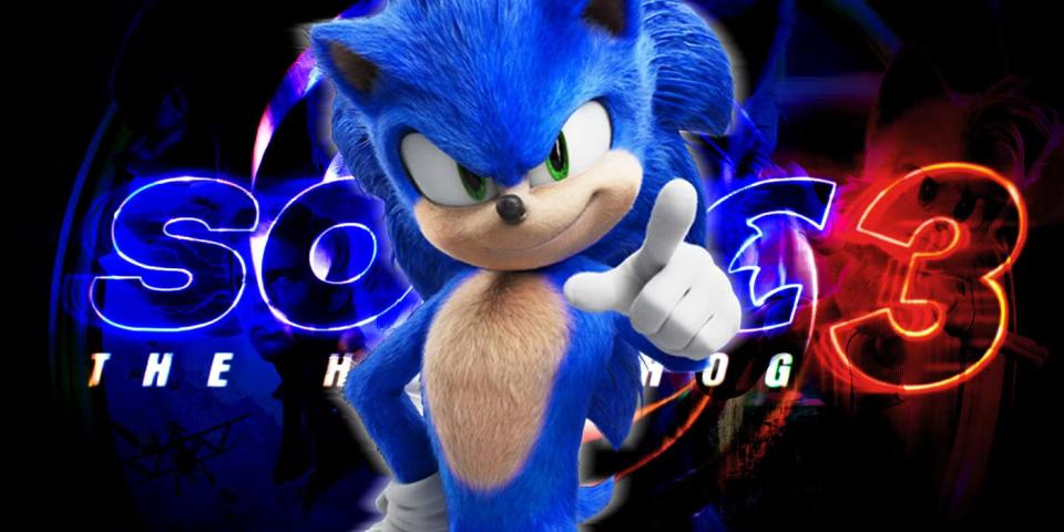 Sonic the Hedgehog stands confidently, pointing, with colorful text behind him.