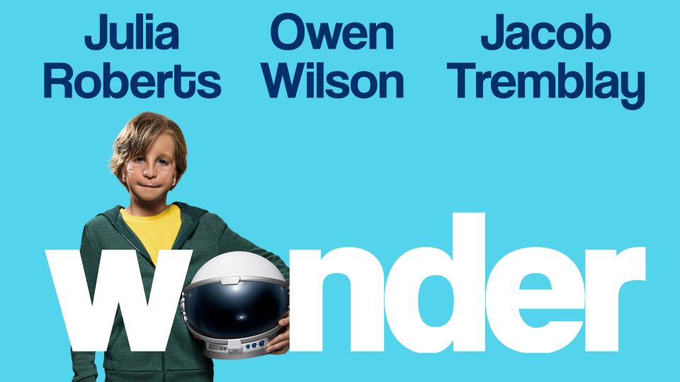 Boy holding a space helmet, text "wonder" in large white font on a blue background.