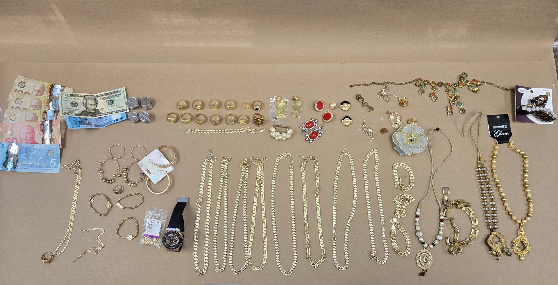 Jewelry and currency laid out on a flat surface.