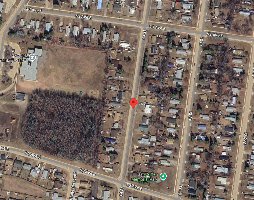 Satellite view of a residential area with a red location marker.