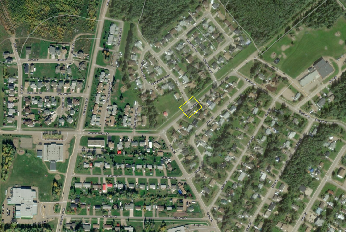 Aerial view of a residential neighborhood with roads and green spaces.